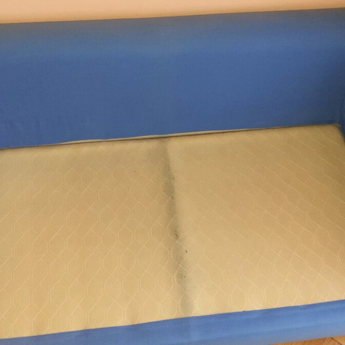 Two-seater sofa used without two back cushions