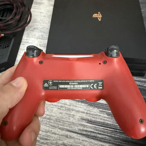 Sony PlayStation 4 Pro 1TB console used with controllers and charging dock