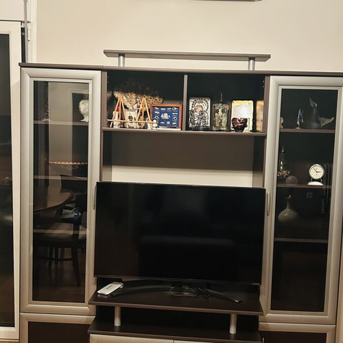 Living room unit like new with glass cabinets and TV space
