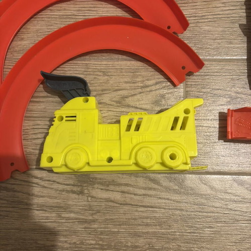 Hot Wheels track set pieces with T-Rex figure and launcher