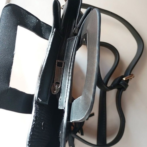 Black Women's Shoulder Bag like new with laser-cut patterns and tassels