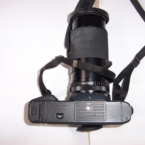 Canon T50 SLR analog camera used with two zoom lenses and flash