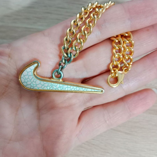 Nike decorative pendant with chain used, gold tone