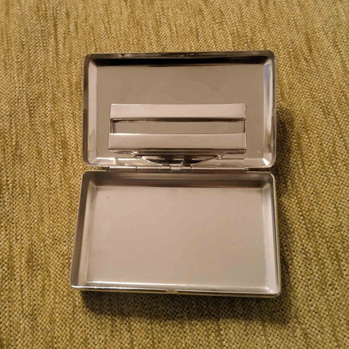 Tobacco case and metal cigarette roller used