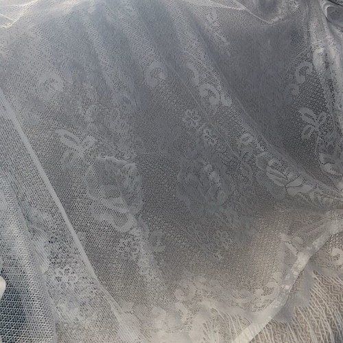 White vintage lace curtain with fringes