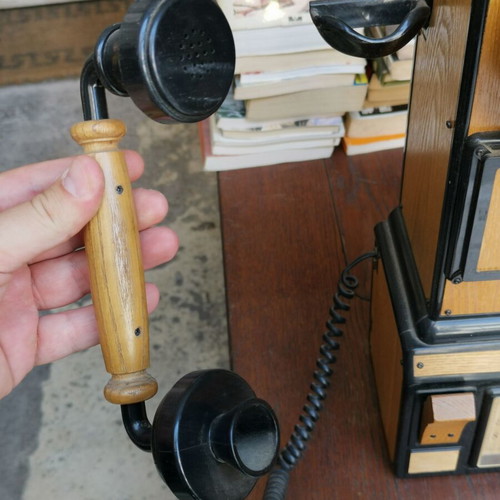 Vintage decorative wall telephone with clock used