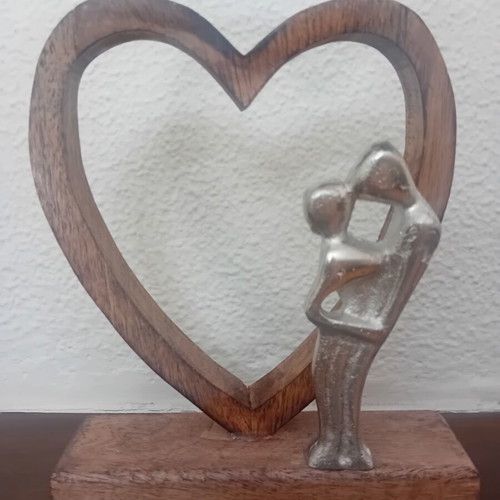 Decorative wooden heart sculpture with couple figure