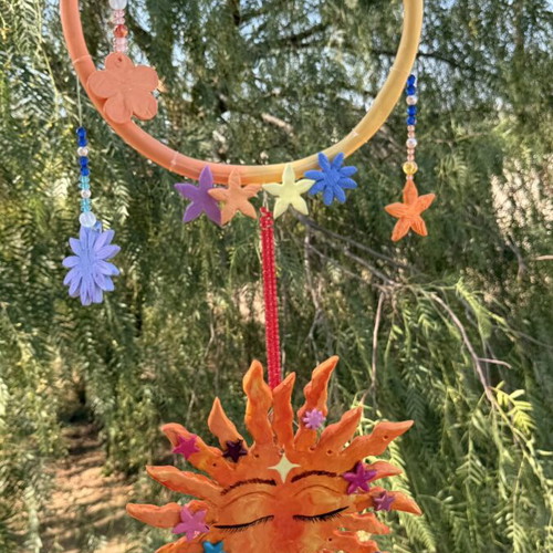 Handmade clay mobile with sun and flowers