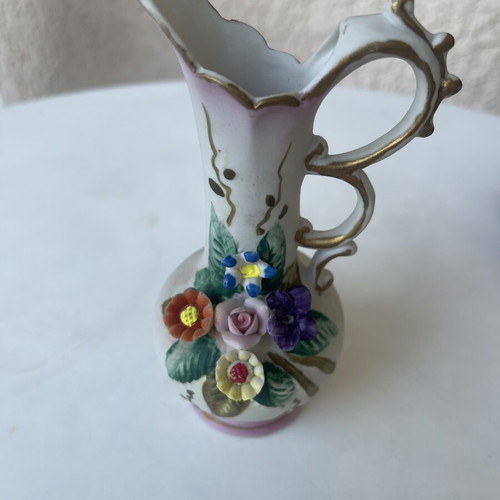 Vintage ceramic pitcher with embossed flowers used