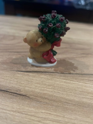 Miniature bear figure with bouquet of roses used