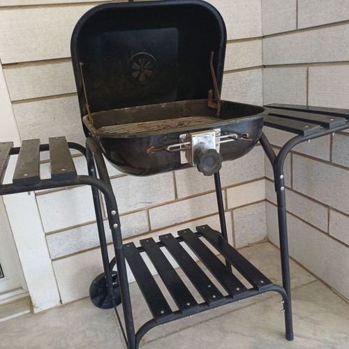 Charcoal grill used, wheeled with shelves and tools