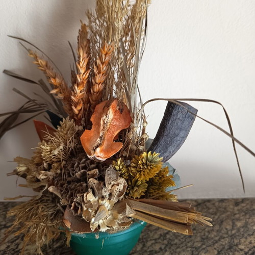 Vintage handmade decorative arrangement with dried stalks used