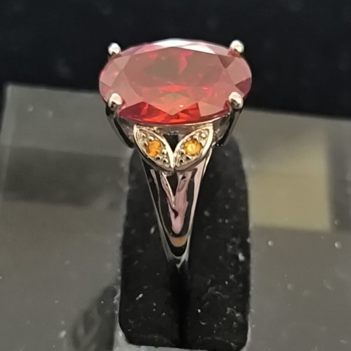 Ring with Large Red Ruby-Colored Stone and Decorative Stones