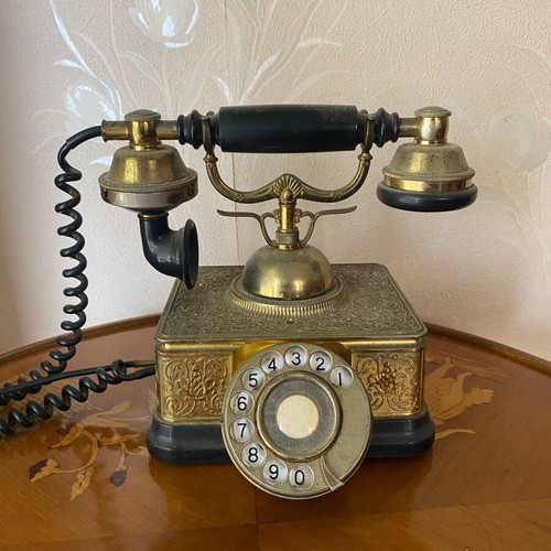 Vintage brass telephone used with embossed designs