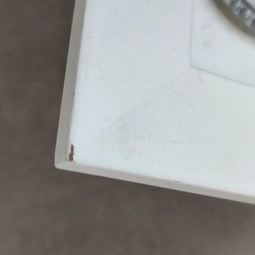 Picture frame hanger used with corner wear