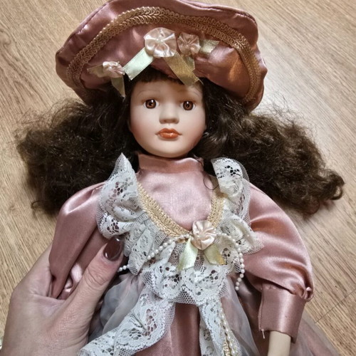 Glass doll like new with satin rotten apple dress and hat