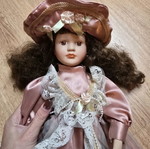 Glass doll like new with satin rotten apple dress and hat