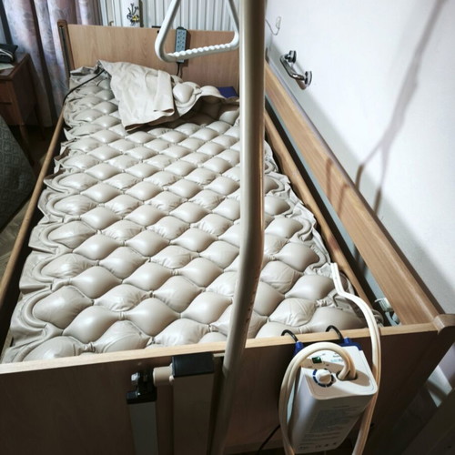 Electric hospital bed with wooden frame, pressure relief mattress and pump
