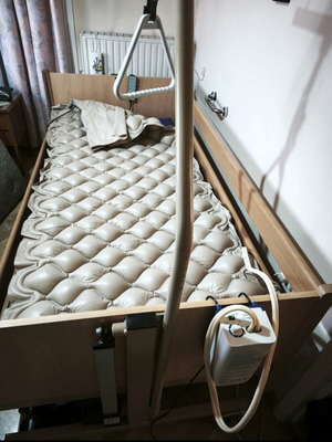 Electric hospital bed with wooden frame, pressure relief mattress and pump