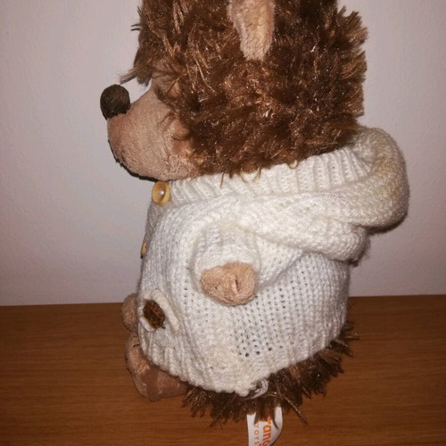 Plush hedgehog used with white knitted jacket