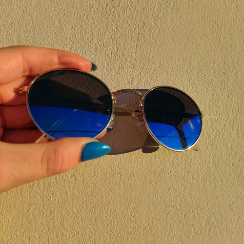 Sunglasses with blue mirror lenses and gold frame