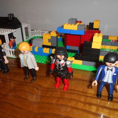 Building toy with Lego bricks and 6 Play Mobil figures used