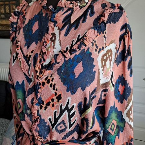 Pom dress used with geometric pattern in pink, blue and green