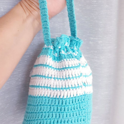 Handmade turquoise knitted pouch toiletry bag used