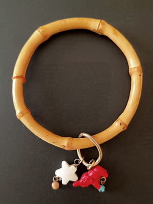 Bamboo bangle with tiki charms like new