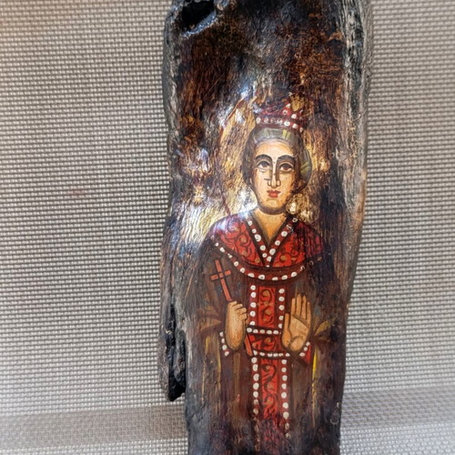 Old religious icon on wood trunk, handmade