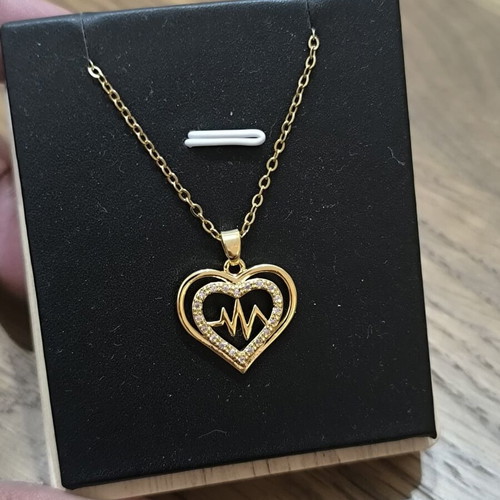 Gold-tone heart necklace with pulse design and sparkling stones