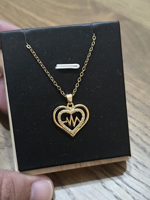 Gold-tone heart necklace with pulse design and sparkling stones