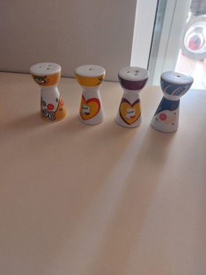 Small decorative containers for salt and pepper
