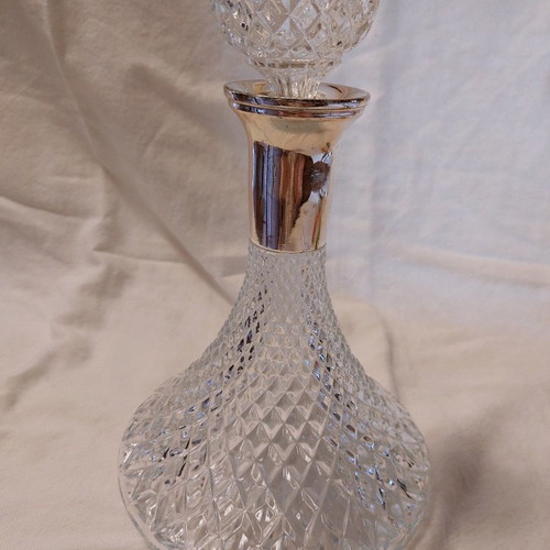 Crystal wine bottle used with silver-plated neck and stopper