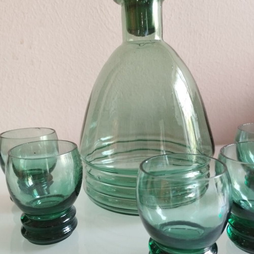 Vintage decanter set with 5 green glass shot glasses used
