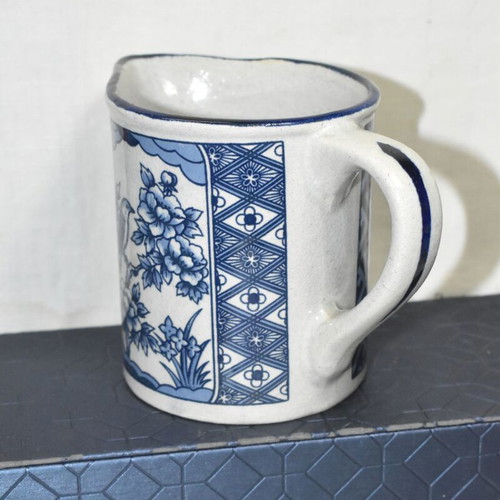 Vintage ceramic jug blue and white with bird and floral motifs used