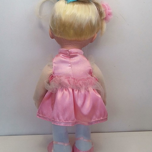Vintage Uneeda doll with pink clothes, blond hair, blue eyes used