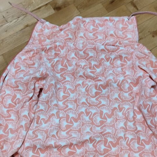 Pink cardigan used with white patterns and zipper, size L