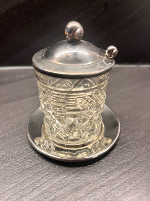 Vintage glass container used for honey or mustard with silver-plated lid and spoon