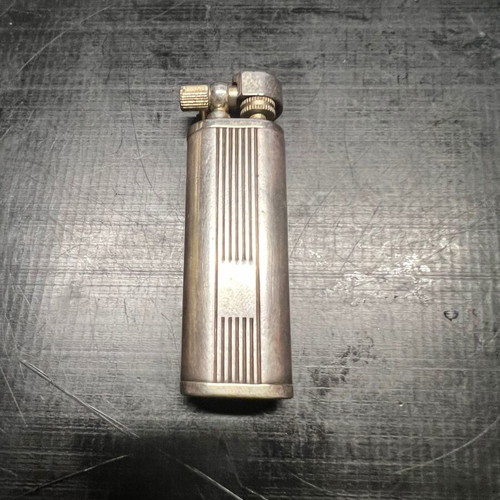 Silver lighter used, unknown if working