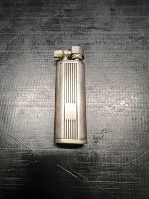 Silver lighter used, unknown if working