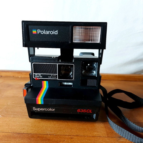 Polaroid Supercolor 635CL vintage instant camera used with strap