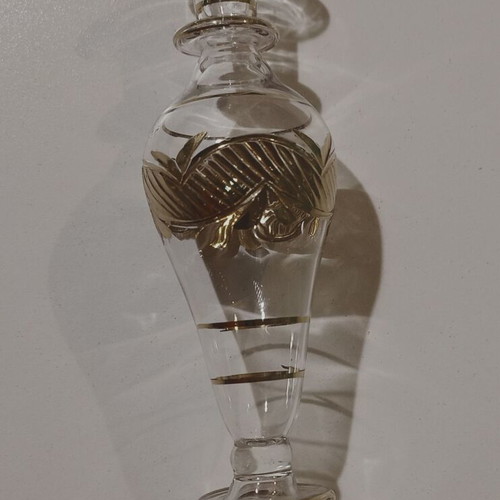 Glass perfume bottle used with golden accents and cap