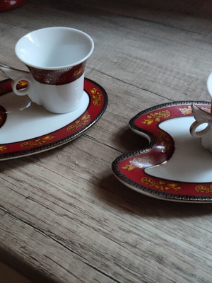 Porcelain tea cups like new with unique asymmetrical feather-shaped saucers