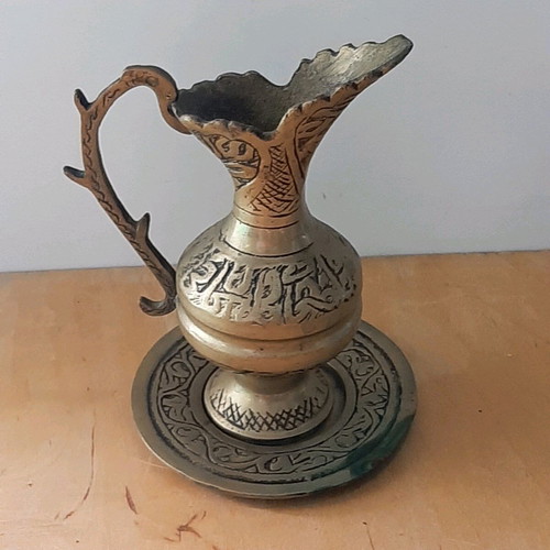 Oriental solid brass pitcher used with saucer