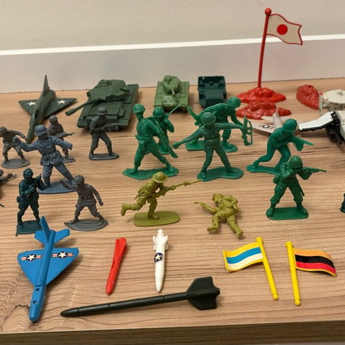Vintage plastic military toys used with vehicles, flags and rockets