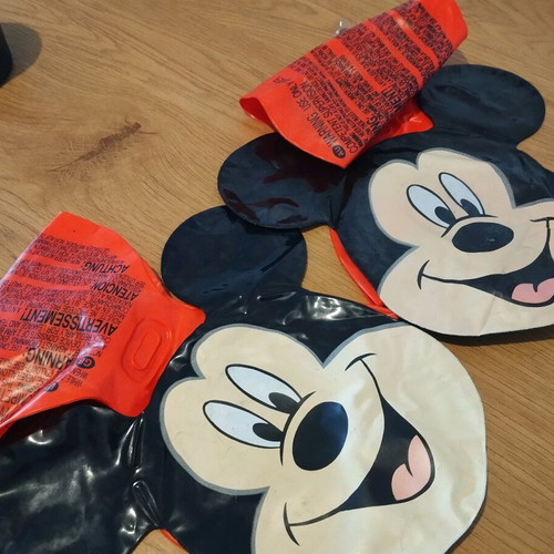 Mickey arm floaties used, red and black with smile