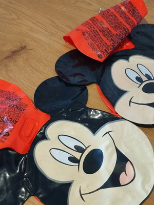 Mickey arm floaties used, red and black with smile