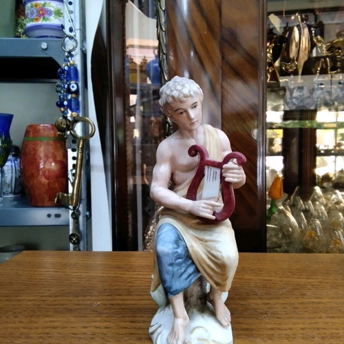Ceramic figurine new with young male figure holding a lyre