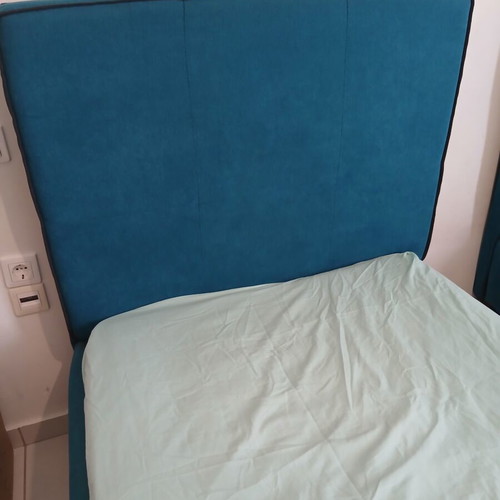 Single bed with teal fabric headboard and mattress, like new